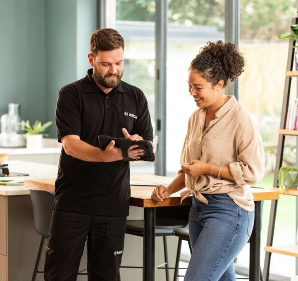 Installer with woman looking at iPad